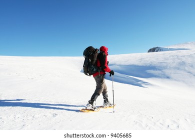 Backpacker in winter mountain