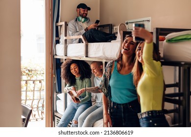 backpackers lifestyle in youth hostel - young people in room with bunk bed - travelers - students in the college dormitory