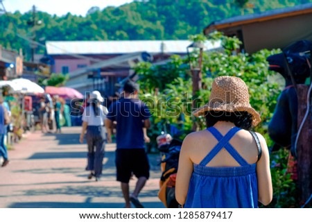 Backside of asian woman travel  in Thailand, She walk in countryside, at E-Tong village, Pilok, Thong Pha Phum, Kanchanaburi, Thailand.