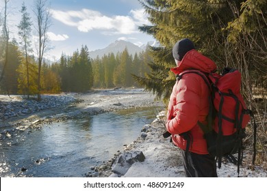 Backside of backpacker looking at winter rocky landscape view