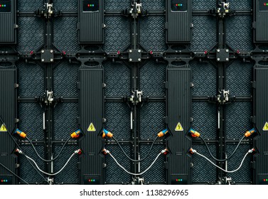 Backside of big LED screen monitor display.  Texture of back view of LED panels. Power input and output wire and data input and output plug. Digital electronic screen. Abstract background.