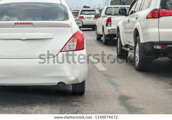 Backside of car has dented rear bumper damaged after\
accident on the road