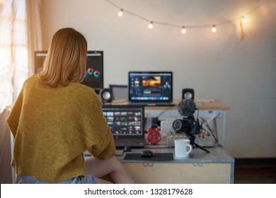 Backside editor video woman working with footage video on laptop and computer pc in the house studio of lifestyle freelance 