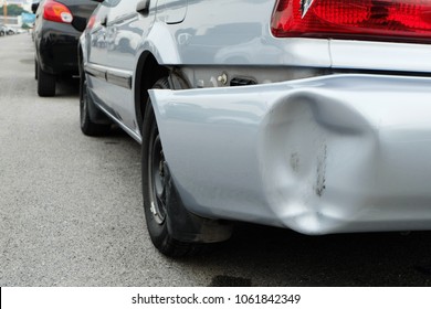 Backside of silver car get damaged by accident.