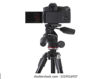 Backside view of modern multifunctional black camera on holder isolated