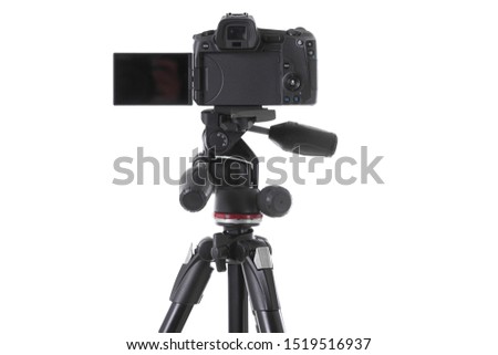 Backside view of modern multifunctional black camera on holder isolated