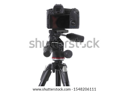 Backside view of modern multifunctional black camera on trepied isolated