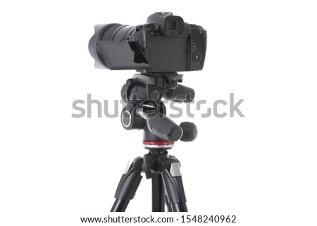 Backside view of modern multifunctional black camera on trepied isolated