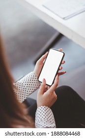 Backside View Of Woman Hand Using Mockup White Screen Mobile Phone.