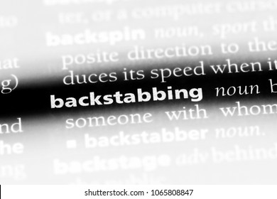 backstabbing word in a dictionary. backstabbing concept.