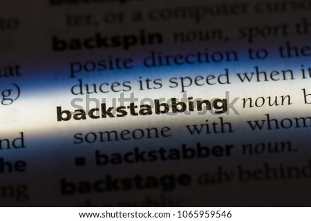 backstabbing word in a dictionary. backstabbing concept.