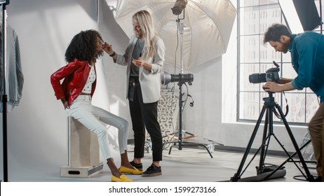 Backstage of the Photo Shoot: Make-up Artist Applies lipstick Makeup on Beautiful Black Model with Lush Curly Hair. Photographer Preparing to Take Pictures. Fashion Magazine Studio Photoshoot - Powered by Shutterstock