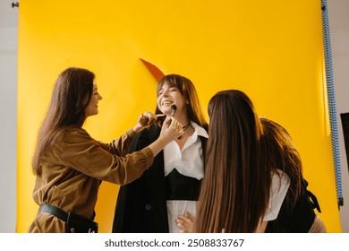 Backstage from the shooting. The photographer and make-up artist together with the model review the references for the photo shoot. - Powered by Shutterstock