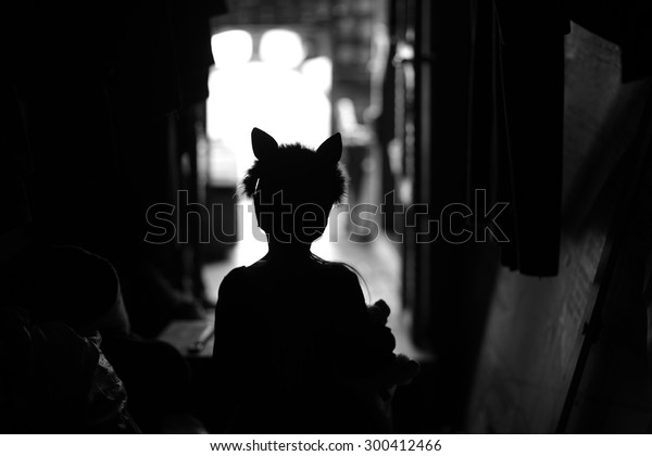 Backstage theater; silhouette of a child actor in cat\
ears handband 