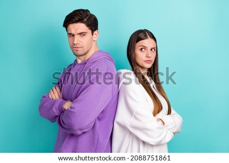 Back-to-back photo of young couple have misunderstanding problem in relationship isolated on blue color background