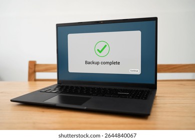 Backup complete notification message on laptop screen.