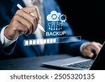 Backup concept, Online digital data storage and connection service. Businessman use laptop with Backup status bar for data backup management. 