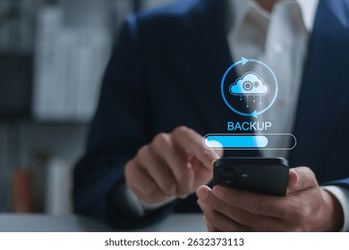 Backup concept, Online digital data storage and connection service. Businessman using smartphone with backup status bar for data backup management.