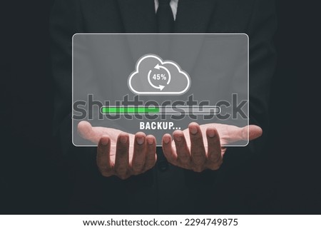 Backup storage data internet technology business concept, Businessman hand holding backup icon on virtual screen.