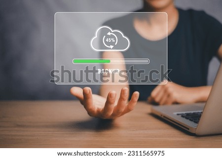 Backup storage data internet technology business concept, Person hand holding backup icon on virtual screen.