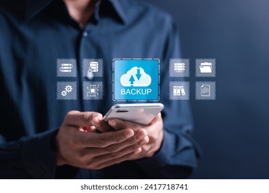 Backup storage data technology concept. Person use smartphone with virtual backup icons for backup online documentation database and digital file storage system or software,file access, doc sharing.