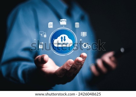 Backup storage data technology concept. Backup online documentation database and digital file storage system or software,file access, doc sharing. Person use smartphone with virtual backup icons. 