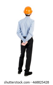 Backview of an engineer in construction helmet stands. Standing young guy. Rear view people collection.  backside view of person.  Isolated over white background. Curly businessman in a light jacket
