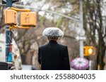 Backview of an orthodox Jew with plastic Cover to protect Hat during Rain