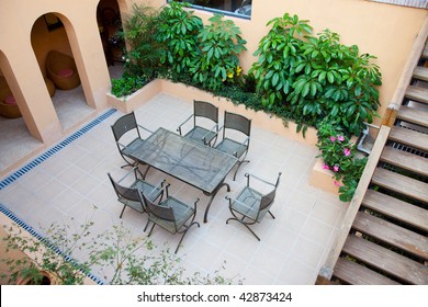 Backyard with chairs and table for resting.