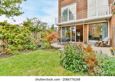 The Backyard Of A Charming House With A Summer Dining Room