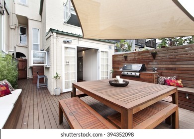 Backyard cozy patio area with wicker furniture set
