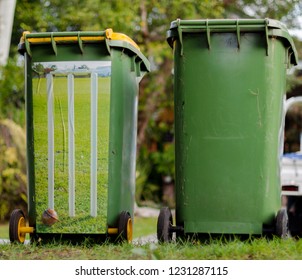 A Backyard Cricket Match Using Two Green Wheelie Rubbish Bins With Stumps Stickers