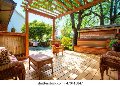 Backyard deck with wicker furniture and pergola. Northwest, USA