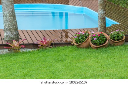 Backyard With Fiberglass Pool And Wooden Deck