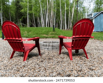 Backyard fire pit with red chairs