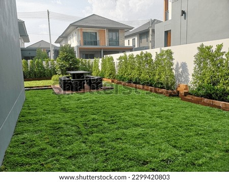 Backyard Garden Modern Design Landscaping. Landscaped Back Yard. Decorative Garden With Pathway Or Walkway From Stone And Rocks Or Gravel. Back Yard Or Park Lawn With Stony Natural landscaping.