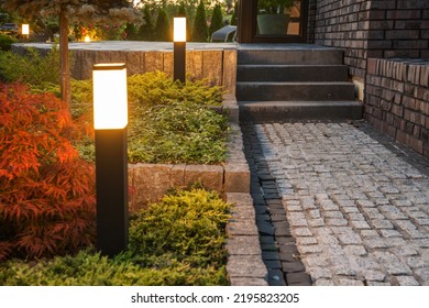 Backyard LED Light Posts Along The Garden Path. Illuminating Landscapes With Modern Outdoor Lighting Systems.