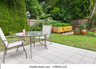 Backyard Patio Garden With Patio Furniture And Raised Garden Beds