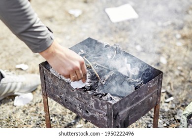 Backyard Picnic. The Man Prepares The Brazier