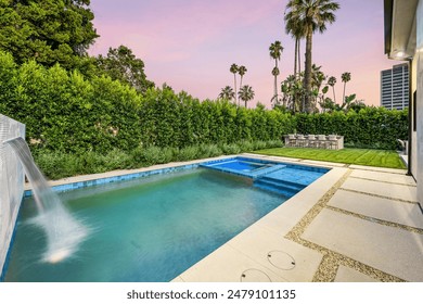A backyard pool surrounded by lush greenery. California, USA