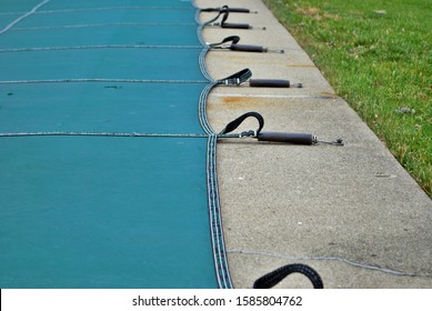 Backyard Swimming Pool With Diving Board And Pool Slide Tarped Up And Closed Down For Winter