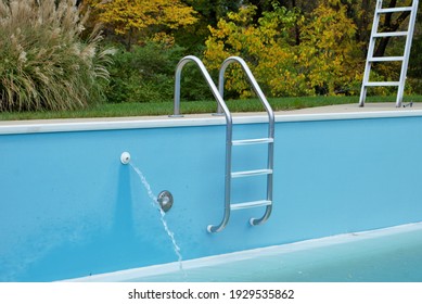 Backyard Swimming Pool With Pool Slide And Ladder Emptied Out Shutting Down For Winter