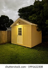 Backyard Tool Shed Outside In A Yard During The Night. Many Trees Are Surrounding The Shed. DIY Project