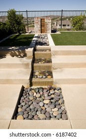 Backyard Water Feature And Green Lawn.