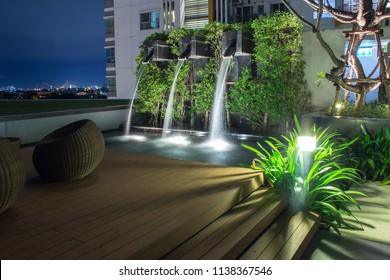 Backyard Waterfall Design.  DIY Outdoor Landscaping For The Home.  Evening Scene With Luxurious Peaceful Fountains.