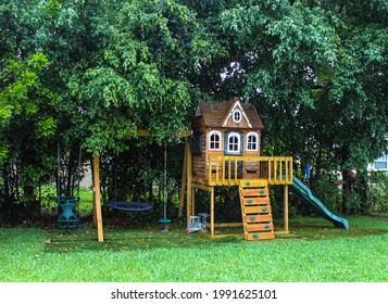 Backyard wooden swing set for kids to play. Summer time activity