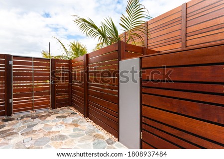 Backyard with wooden wall of modern house