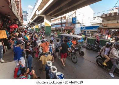 Baclaran, Paranaque, Metro Manila, Philippines - Nov 2021: A typical scene in Baclaran, with streets encroached by sidewalk vendors selling clothes and other products.