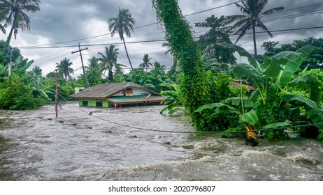 BACO, PHILIPPINES - Jul 23, 2021: Rising water levels submerge a house as heavy monsoon rains cause major floods on Mindoro Island 