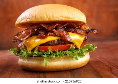 Bacon burger with beef patty on wooden table - Powered by Shutterstock